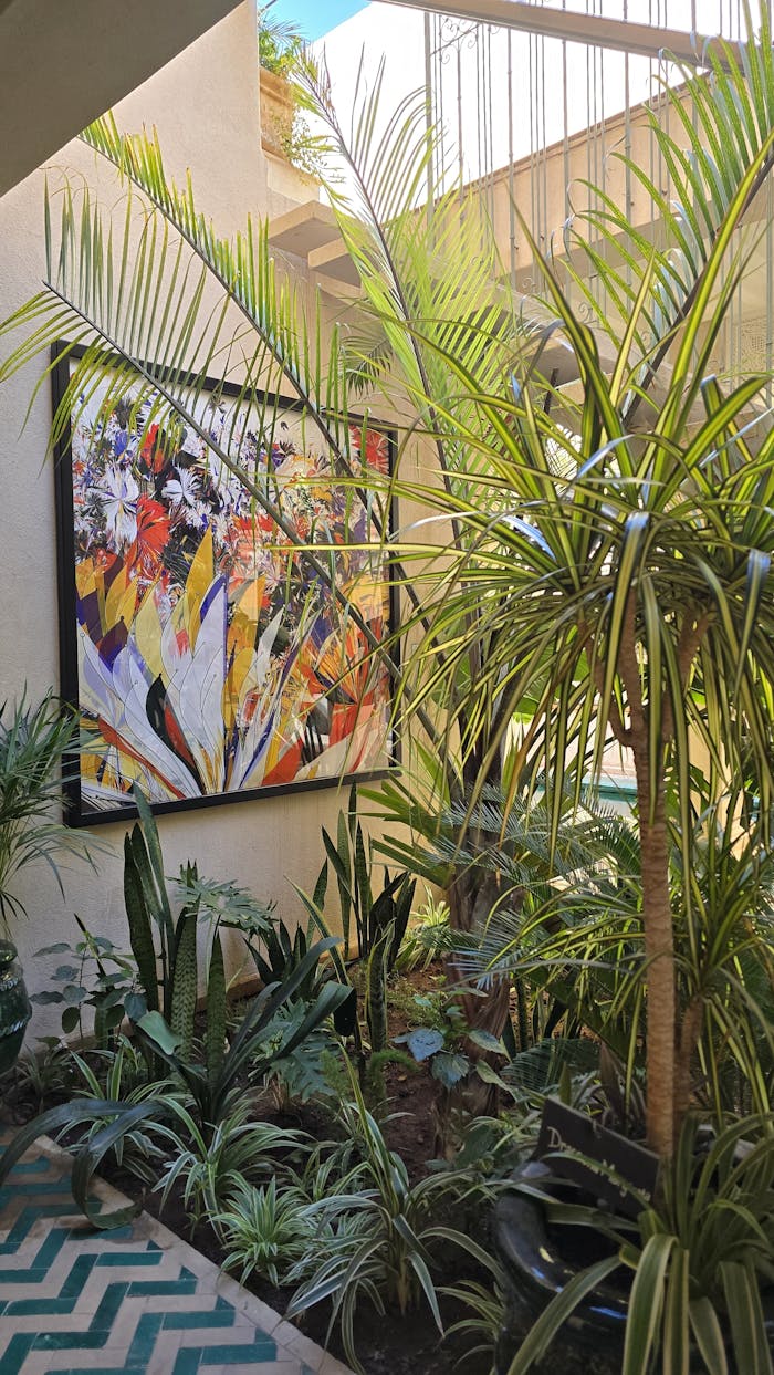 Lush indoor garden with vibrant plants and colorful abstract art, creating a refreshing ambiance.