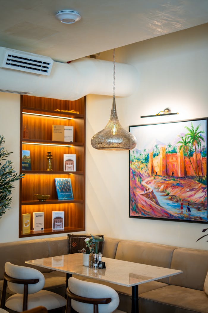 Stylish cafe interior in Dubai featuring modern decor and vibrant artwork creating a cozy ambiance.